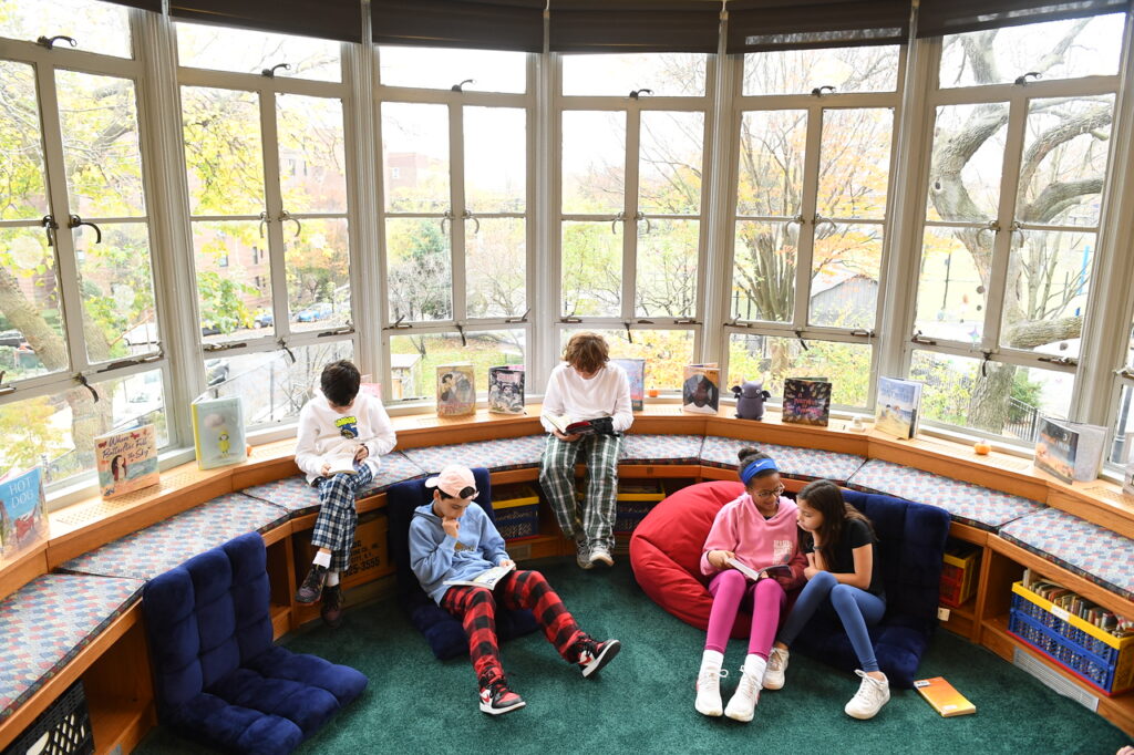 Photo of students reading in Fieldston Lower library nook.