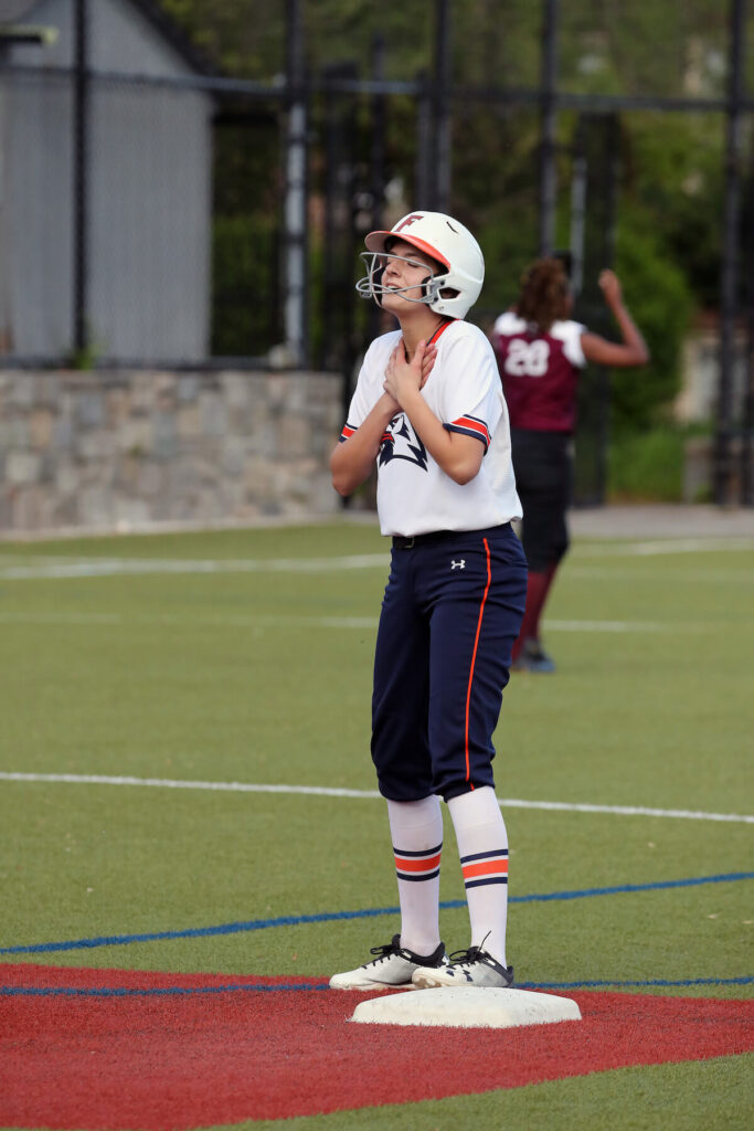 Ethical Culture Fieldston School Baseball Team member exhales in relief for arriving safely on base