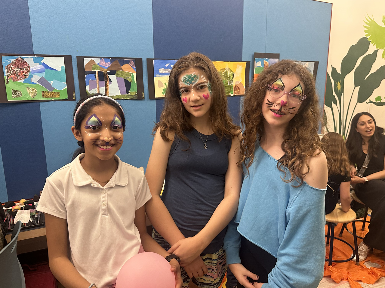 ethical culture fieldston school ethical culture students smile with their faces painted at the community Spring Fest. 