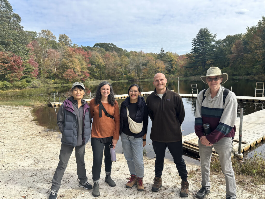 Ethical Culture chaperones pose together in front of lake.