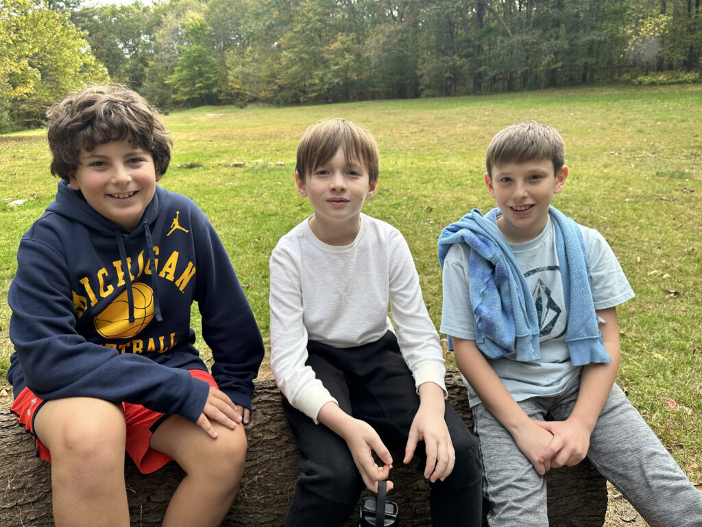 Ethical Culture students pose around firepit at Nature's Classroom.