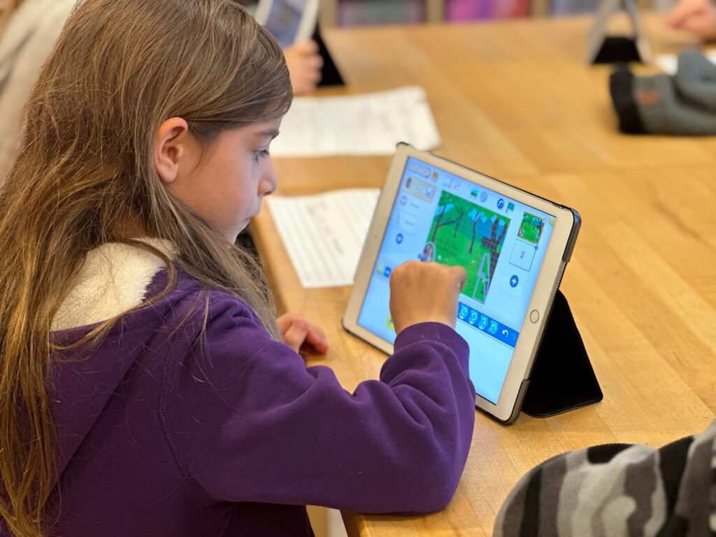 Fieldston Lower student makes adjustments to her video on iPad.