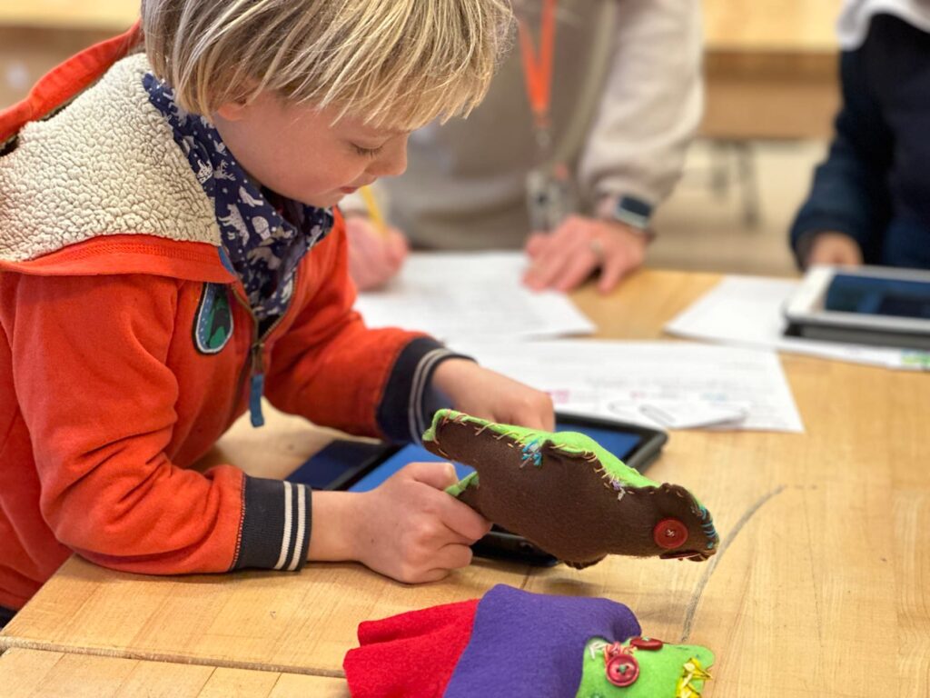 Fieldston Lower student plays with his stuffy in the classroom.