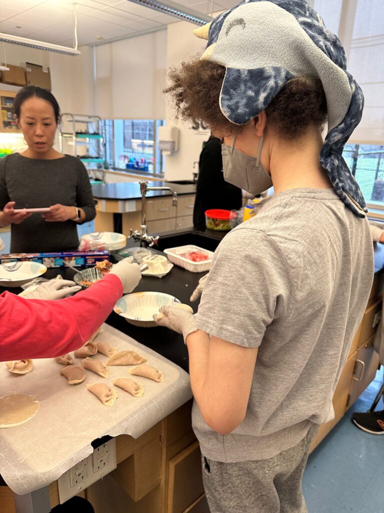 Fieldston Middle student wraps dumpling.