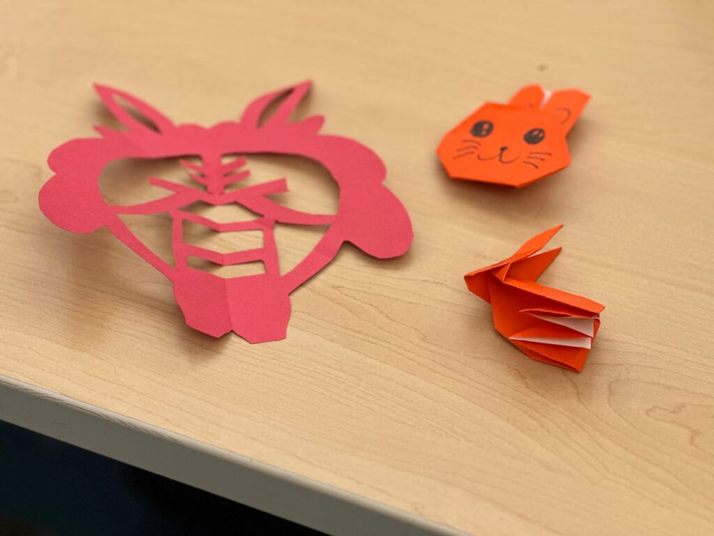Photo of paper rabbit cutouts and origami made by Fieldston Middle students.