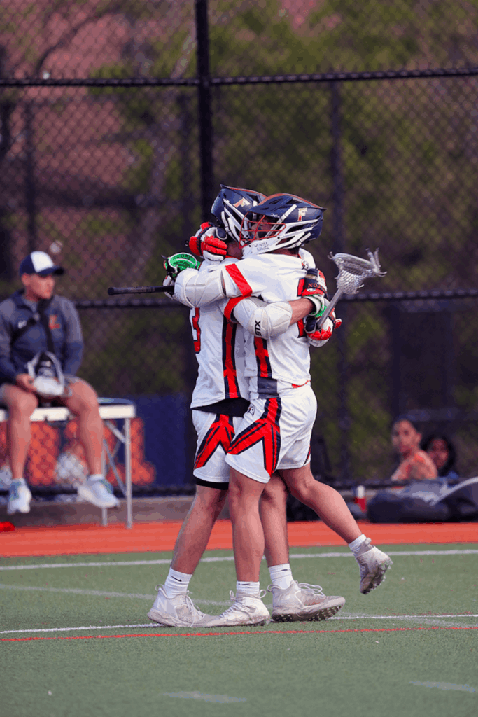 Two Ethical Culture Fieldston lacrosse players hug it out at Spring Fling.