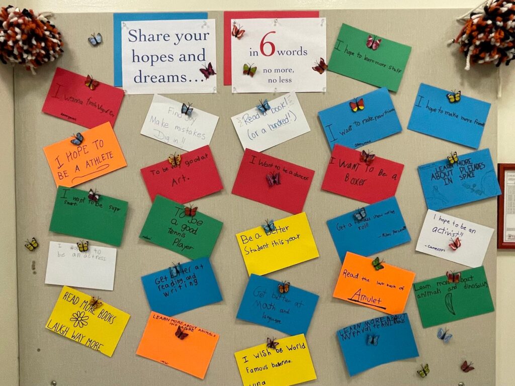 A collection of colorful note cards shows a collection of hopes and dreams, including "Get better at math and language" "Read more books, laugh way more" and "I want to make new friends"