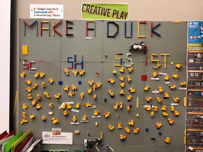 Student lego ducks hanging on bulletin board