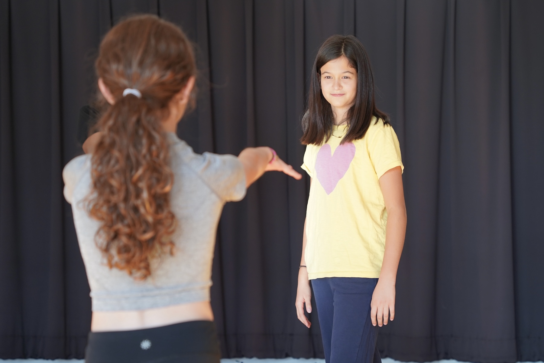 Two Fieldston Middle students practice a mirroring exercise in a dance class